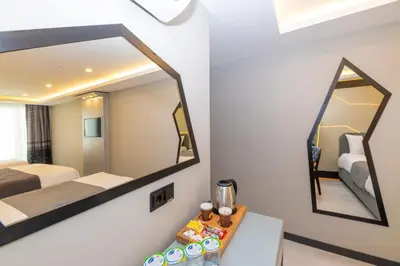 a room with a bed and a mirror at White Corner Hotel in Istanbul