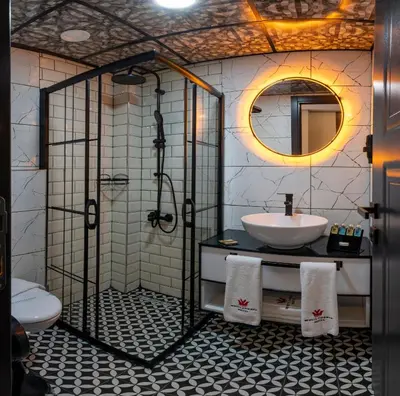 a bathroom with a shower and a sink and a mirror at White Corner Hotel in Istanbul