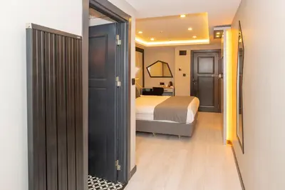 a bedroom with a bed and a door leading into a room at White Corner Hotel in Istanbul