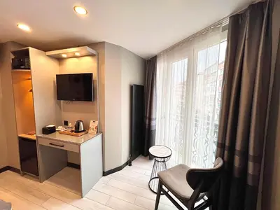 a hotel room with a desk and a window at White Corner Hotel in Istanbul