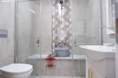 a bathroom with a shower and a toilet and a sink at GREEN SUITES BURSA in Bursa