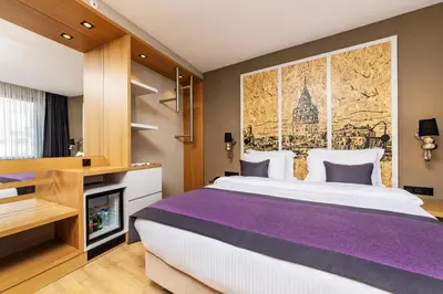 a bedroom with a large bed and a fireplace at The Halich Hotel Istanbul Karakoy - Special Category in Istanbul