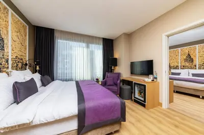 a hotel room with a bed and a tv at The Halich Hotel Istanbul Karakoy - Special Category in Istanbul