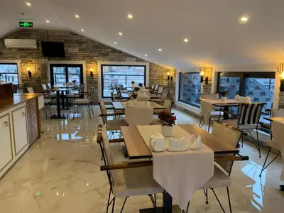 a restaurant with tables and chairs and a brick wall at Mr BEYAZ HOTEL in Istanbul