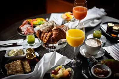 a table with breakfast foods and glasses of orange juice at CHER HOTEL & SPA Taksim in Istanbul