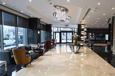 a lobby with a table and chairs and a chandelier at CHER HOTEL & SPA Taksim in Istanbul