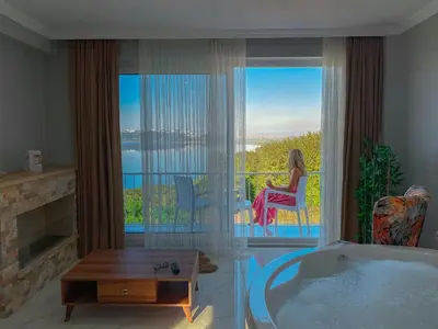 a woman sitting in a chair in a room with a tub at Sapanca View Hotel in Sapanca