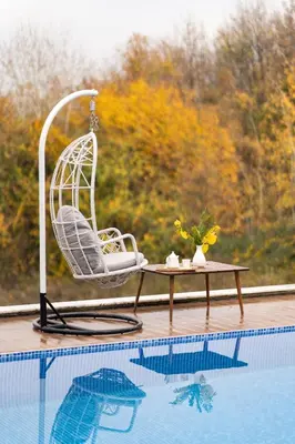 a chair and a table next to a swimming pool at Sapanca View Hotel in Sapanca
