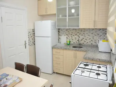a kitchen with a stove and a white refrigerator at Yilmaz Apart in Istanbul