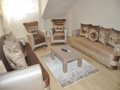 a living room with couches and chairs and a table at Yilmaz Apart in Istanbul