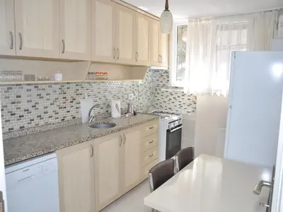 a kitchen with wooden cabinets and a white refrigerator at Yilmaz Apart in Istanbul