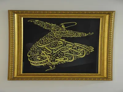 a gold painting of a bird on a blackboard at Yilmaz Apart in Istanbul