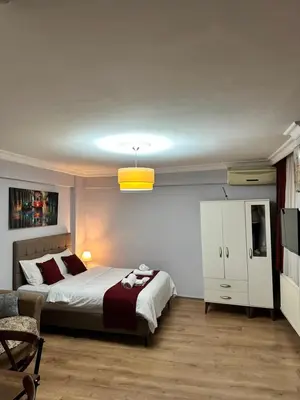 a bedroom with a bed and a white cabinet at Taksim Rain Suite in Istanbul