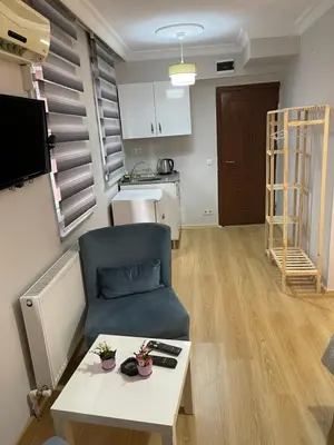a living room with a blue chair and a table at Taksim Rain Suite in Istanbul
