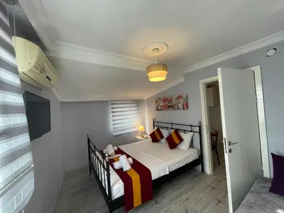 a bedroom with a bed with red and yellow pillows at Taksim Rain Suite in Istanbul