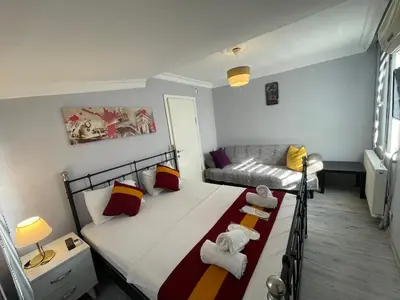 a small bedroom with a bed and a couch at Taksim Rain Suite in Istanbul