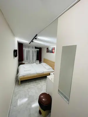 a small room with a bed and a mirror at Taksim Rain Suite in Istanbul