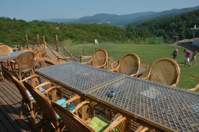 a table and chairs sitting on top of a deck at Zumrut Bahce in Gokcedere