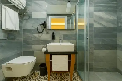 a bathroom with a toilet and a sink and a shower at FRT AİRPORT OTEL in Arnavutköy
