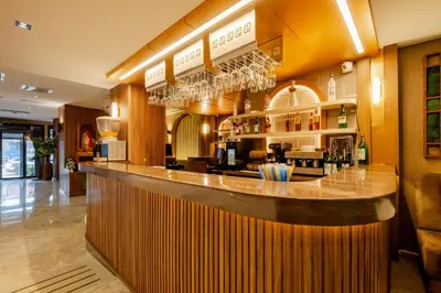 a bar in a restaurant with glasses on the wall at FRT AİRPORT OTEL in Arnavutköy