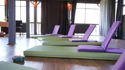 a row of yoga mats on the floor in a room at Treetops Park Hotel in Sile