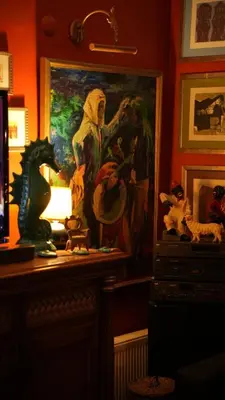 a room with a painting on the wall and a table with toys at Treetops Park Hotel in Sile