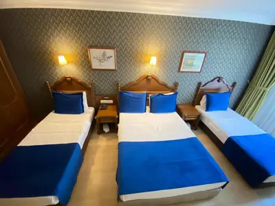 two beds in a room with blue and white at Hotel Büyük Levent in Istanbul