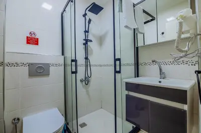 a bathroom with a shower and a toilet and a sink at Taksim Wonder Suites in Istanbul