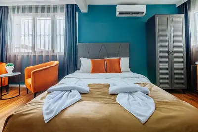 a bedroom with a large bed with blue walls at Taksim Wonder Suites in Istanbul
