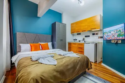 a bedroom with a bed and a blue wall at Taksim Wonder Suites in Istanbul