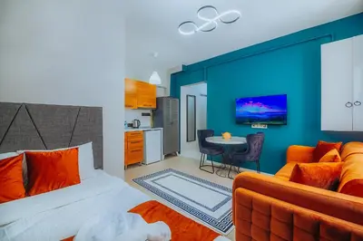 a bedroom with a bed and a kitchen with a table at Taksim Wonder Suites in Istanbul