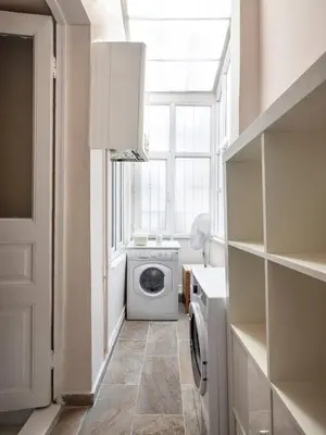 a laundry room with a washing machine and a window at High Ceiling Authentic Historic Ottoman Home! #49 in Istanbul