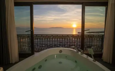 a bath tub in a room with a view of the ocean at La Cielo Hotel Bostancı in Istanbul