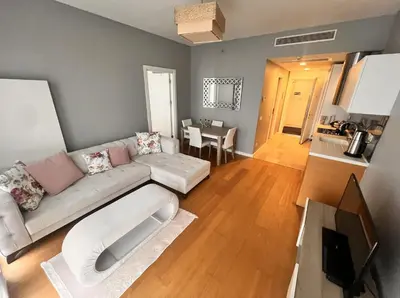 a living room with a couch and a table at Divan Residence - Güneşli Near Ataköy Metro Station in Istanbul