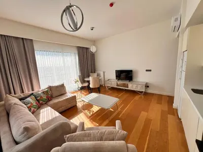 a living room with a couch and a table at Divan Residence - Güneşli Near Ataköy Metro Station in Istanbul