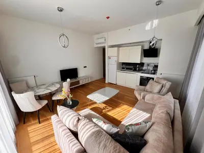 a living room with a couch and a table at Divan Residence - Güneşli Near Ataköy Metro Station in Istanbul