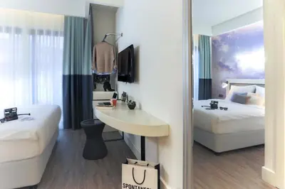 a hotel room with two beds and a mirror at Anemon Bakırköy in Istanbul
