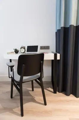 a desk with a chair and a laptop on it at Anemon Bakırköy in Istanbul