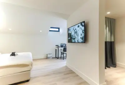 a living room with a couch and a tv on the wall at Anemon Bakırköy in Istanbul