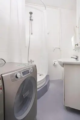 a washing machine in a bathroom with a sink at Cozy Apartment Next to Taksim Square in Istanbul