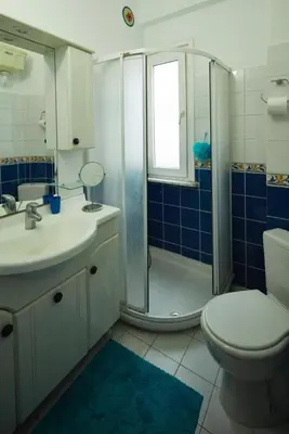 a bathroom with a shower and a toilet and a sink at Cozy Apartment Next to Taksim Square in Istanbul