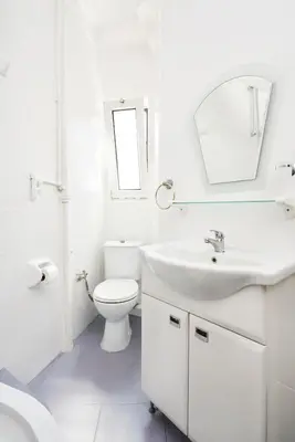 a white bathroom with a sink and a toilet at Cozy Apartment Next to Taksim Square in Istanbul