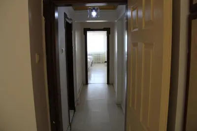 a hallway with a hallway leading to a room with at Abbasi Apart (H) in Çekirge