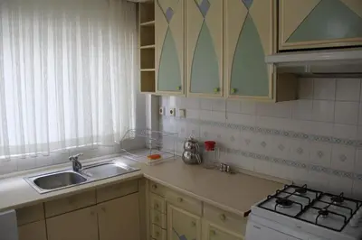 a kitchen with a sink and a stove at Abbasi Apart (H) in Çekirge