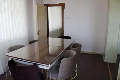 a conference room with a glass table and chairs at Abbasi Apart (H) in Çekirge