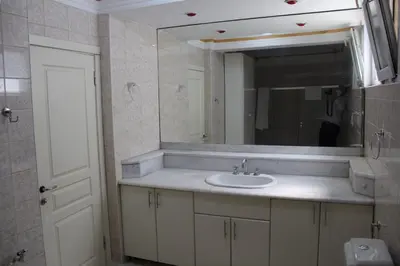 a bathroom with a sink and a mirror at Abbasi Apart (H) in Çekirge