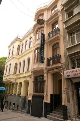 a large building with a sign on the side of it at Castle Franco Suites in Istanbul