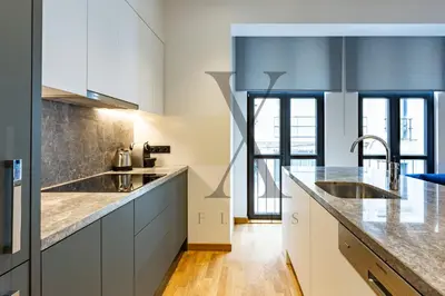 a kitchen with white cabinets and stainless steel appliances at X Flats Vilhelm in Istanbul