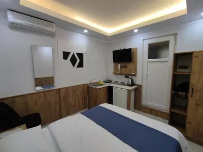a bedroom with a bed and a small kitchen at Life Span Hotels in Istanbul