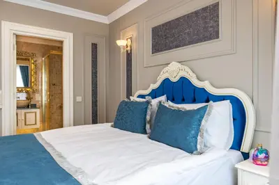 a bedroom with a blue and white bed with blue pillows at Begonville Mansion Oldcity in Istanbul